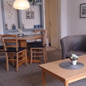 a living room with a table and chairs at Ferienwohnung Gentzen in Baabe