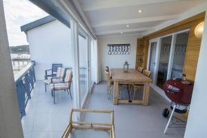 a dining room with a table and chairs on a balcony at Laguna Grove 15 3 bedroom apartment in Knysna