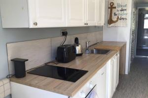 a kitchen with a sink and a counter top at Mudeford Mews in Mudeford
