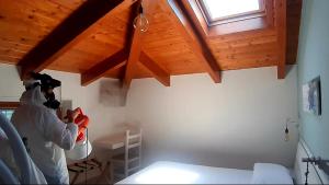 a person in a room working on a wooden ceiling at APPARTAMENT '' IL GIARDINO '' in Santa Maria La Carità