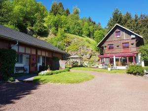 una casa con una entrada de grava junto a un edificio en Gîte tout confort 4 personnes en Besse-et-Saint-Anastaise