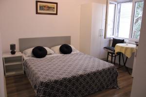 a bedroom with a bed with two pillows on it at Superior apt, 4 rooms, 4 bathrooms in Promajna