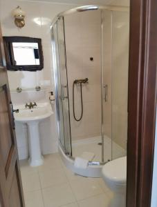 a bathroom with a shower and a toilet and a sink at Villa Watamu in Trzęsacz