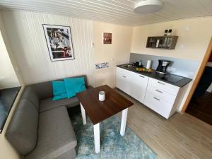 a small living room with a couch and a table at Apartment am Kaffelstein - mit Terrasse in Kreuzwertheim