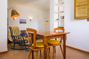 a dining room with a wooden table and chairs at La Atalaya del Río Seco in Almuñécar