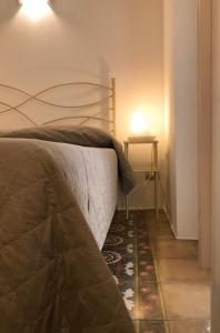 a bedroom with a bed and a rug on the floor at B&B Casa Dorsi in Polignano a Mare