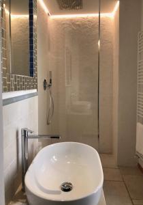 a bathroom with a sink and a shower with a toilet at B&B Casa Dorsi in Polignano a Mare