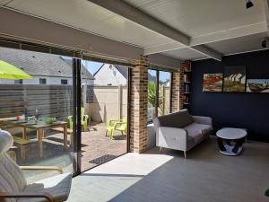 a living room with a couch and a table at Holiday Home Maison de l'Océan à Denneville in Denneville