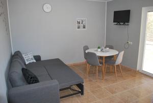a living room with a couch and a table at Apartmani Ivan in Kaprije