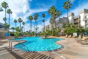 a swimming pool at a resort with palm trees at Condo in Beachfront Resort B-212 in Oceanside +16 photos