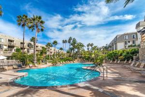 a swimming pool at a resort with palm trees at Condo in Beachfront Resort B-212 in Oceanside