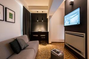 a living room with a couch and a flat screen tv at Design Club Collection in Bologna