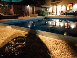 a swimming pool at night with its reflection in the water at Casa Francesca Altea piscina y aparcamiento privado in Altea