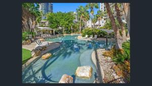 a swimming pool with rocks in a resort at Bridgewater Apartments in Brisbane