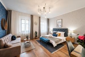 Un dormitorio grande con una cama y un sofá. en Penzion Mácha, en Litoměřice