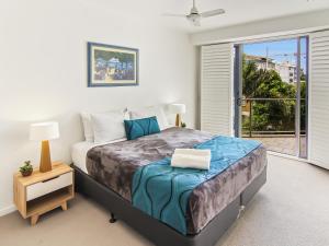 a bedroom with a large bed and a window at Space Holiday Apartments in Maroochydore +65 photos