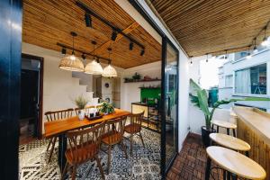 a kitchen and dining room with a table and chairs at The Autumn Homestay in Hanoi