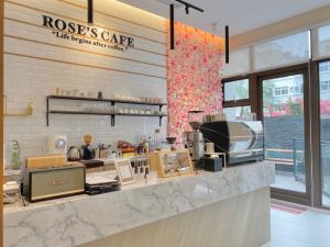 a coffee shop with a counter with aasteryasteryasteryasteryasteryasteryasteryastery at Champ De Rose Hotel in Hualien City