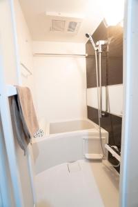 a bathroom with a shower and a bath tub at Hill Side Terrace Hiroo Shibuya 201 in Tokyo