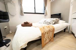 a bedroom with two beds and a mirror at Hill Side Terrace Hiroo Shibuya 202 in Tokyo