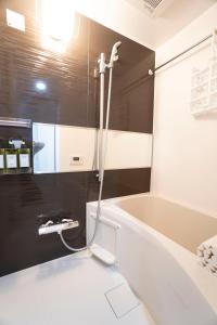 a bathroom with a white tub and a shower at Hill Side Terrace Hiroo Shibuya 202 in Tokyo +21 photos