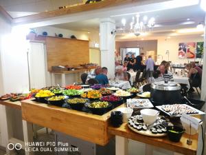 a buffet of food on a table in a restaurant at Astoria Galilee Hotel in Tiberias