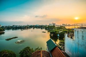 a view of a river in a city at sunset at The Autumn Homestel in Hanoi