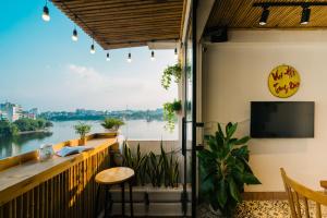 a balcony with a view of the river at The Autumn Homestay in Hanoi