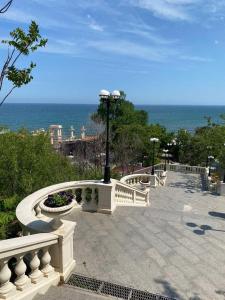 a park with a street light and a view of the ocean at Апартаменты Аркадия in Odesa