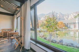 a room with a window with a view of a mountain at Guan Sam Hotel in Beijing