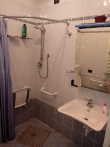 a bathroom with a sink and a shower with a mirror at Appartamento Versilia lungomare in Marina di Pietrasanta