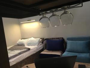 a room with a couch and a laptop and lights at Cozy Home in Old Tbilisi. in Tbilisi City