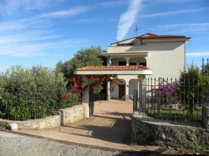 ein weißes Haus mit einem Tor und Blumen in der Unterkunft Seamoon Residence in Marina di Camerota