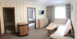 a hotel room with a bed and a living room at For You in Odesa