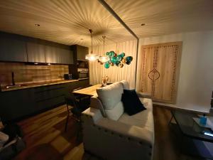 a living room with a couch and a dining table at Alvarado Loft Rural in Ubrique