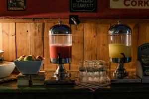 a counter with two different colored drinks in a blender at Canyon Roadhouse Campsite in Karasburg