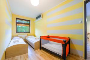 Posteľ alebo postele v izbe v ubytovaní Apartamenty Sun & Snow Jasny Brzeg