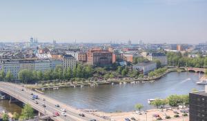 a view of a city with a river and a bridge at Sky Hostel Helsinki in Helsinki