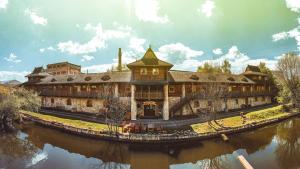 a large building next to a body of water at Resort Svět in Úžice