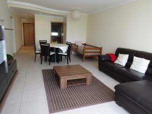 a living room with a couch and a table at Alltravel Primavera Apartment in Portimão