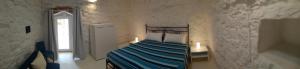 A bed or beds in a room at Trullo Le Macchie
