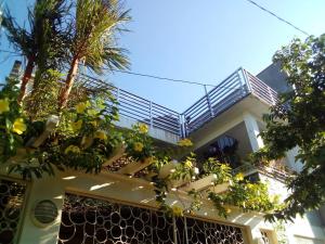 a house with a balcony with plants on it at Ellens Homestay in Irosin