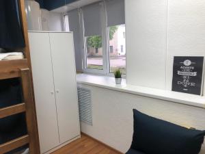 a room with a window and a counter with a pillow at Хостел Sleep&Go Великий Новгород in Velikiy Novgorod