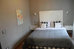 a bedroom with a large bed in a room at Gombereto 10 in Bagni di Lucca