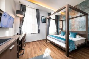 a bedroom with a bed and a desk at Opera Garden Hotel & Apartments in Budapest