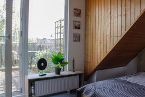 a bedroom with a bed and a large window at Hotel Pilar Garni in Cologne