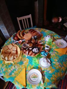 a table with bread and other food on it at Zizzihome Bed and Breakfast in Orta San Giulio