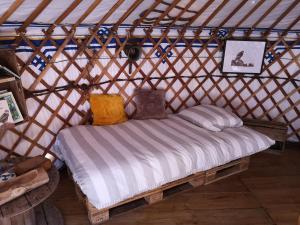 a bed in a yurt with a mattress at Yourte Mont-Saint-Michel in Jullouville-les-Pins