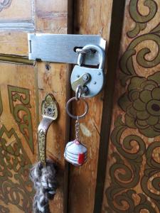 a lock on a door with a key at Yourte Mont-Saint-Michel in Jullouville-les-Pins