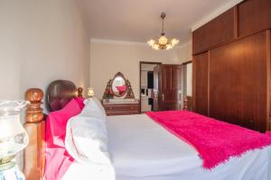 フンシャルにあるMaravilhas Houseのベッドルーム(ピンクの枕が付く大きな白いベッド付)